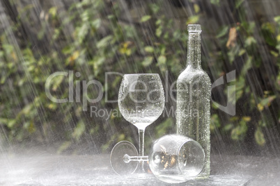 Wine Bottle and Glasses in Summer rain