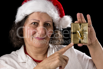 Mature Woman with Red Cap Pointing at Golden Gift