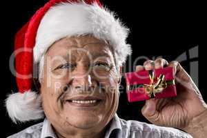 Aged Gentleman with Red Cap Holding Small Gift