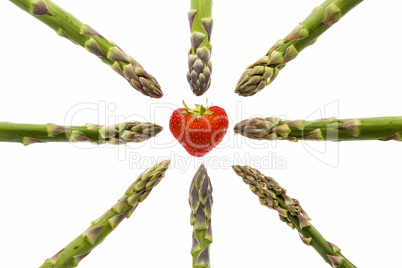 Eight Asparagus Tips Pointing at One Strawberry