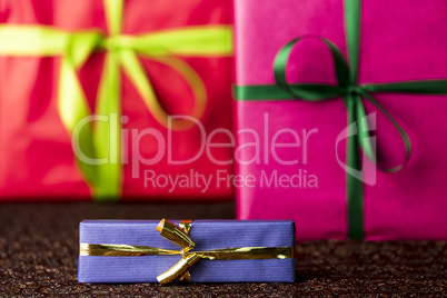 Three presents, bows and ribbons.