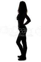Silhouette of young woman full length