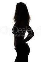 Silhouette of young woman with nude belly