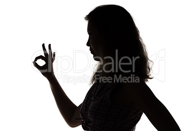 Silhouette of girl showing ok