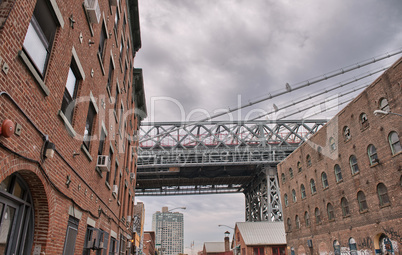 Metallic structure of Manhattan Bridge among classic Brooklyn bu