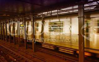 Silver Train speeding up on a subway station interior