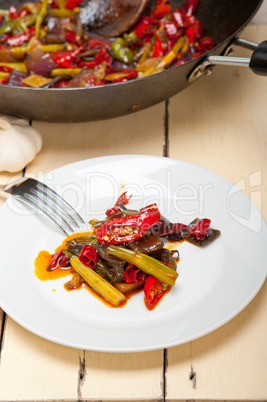 fried chili pepper and vegetable on a wok pan