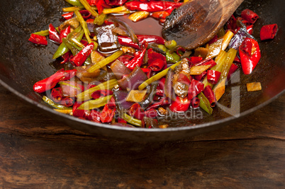 fried chili pepper and vegetable on a wok pan