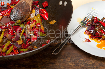 fried chili pepper and vegetable on a wok pan