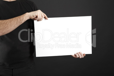 Man in black clothes holds poster