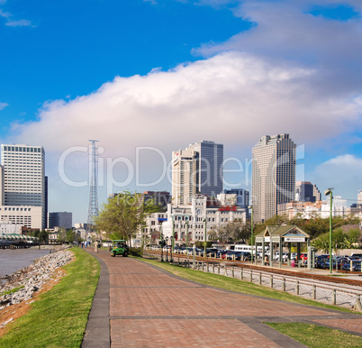 New Orleans skyline with beautiful riverwalk at sunset