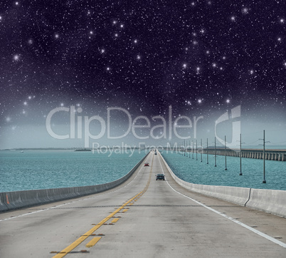 Infinite road to the ocean with stars in the night