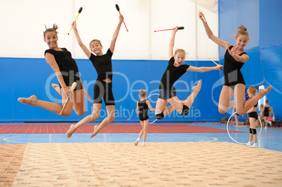 Girls with Indian clubs during high jump