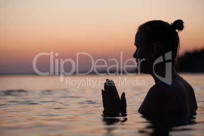 Woman in water during pray or meditation