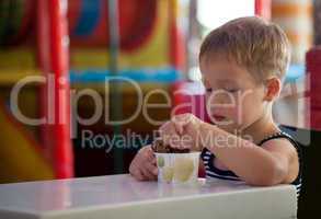 Little child eating chocolate ice cream