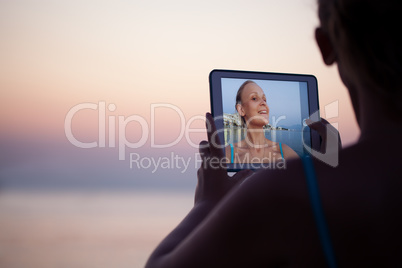Woman making selfie on resort using pad