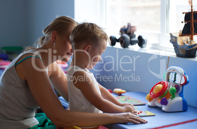 Mother playing learning game with son