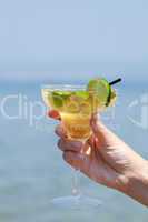 Womans hand holding a glass of cocktail