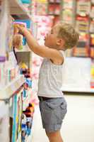 Boy choosing toy in the shop
