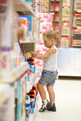 Boy watching cars in the toy shop