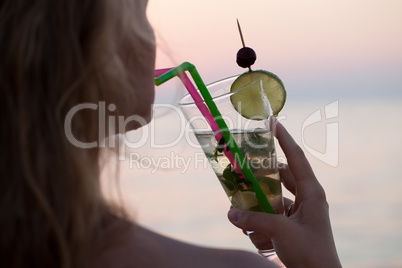 Woman drinking mojito cocktail