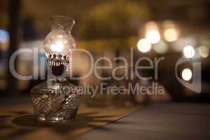 Antique oil lamp with dim light on table in cafe