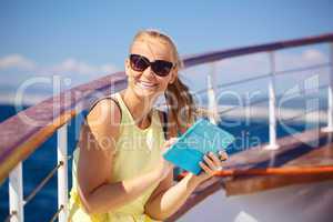 Happy woman with pad during sea traveling