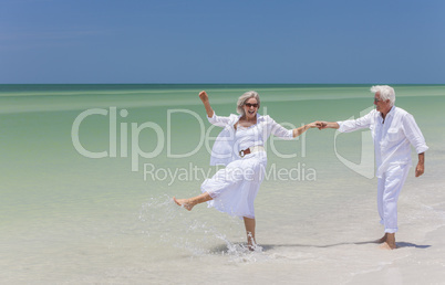 Happy Senior Couple Dancing Holding Hands on A Tropical Beach