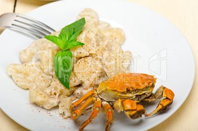 Italian gnocchi with seafood sauce with crab and basil