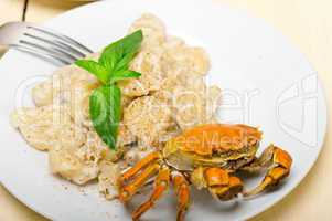 Italian gnocchi with seafood sauce with crab and basil
