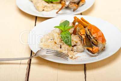 Italian gnocchi with seafood sauce with crab and basil
