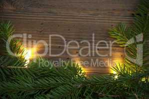 Wooden Background wiht Copy Space, Fir Tree Branches and Fairy Lights