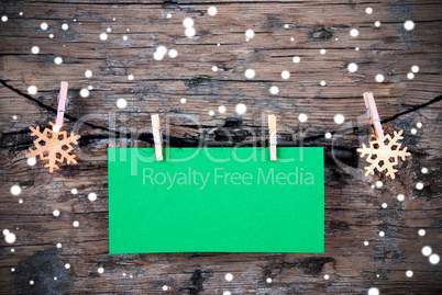 Empty Green Label with Snow on Wooden Background