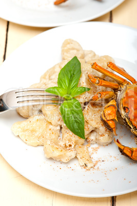 Italian gnocchi with seafood sauce with crab and basil