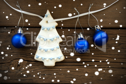 Christmas Tree and Christmas Balls Hanging on a Line on Wood
