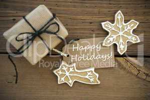 White Happy Holidays on a Banner with Christmas Decoration