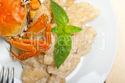 Italian gnocchi with seafood sauce with crab and basil