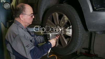 Car Repair Mechanic Changing Wheel