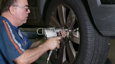 Car Repair Mechanic Mounts Wheel