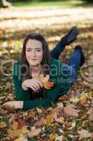 Woman lying in autumnal park