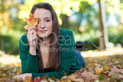 Woman lying in autumnal park