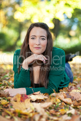 Woman lying in autumnal park