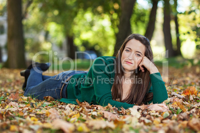 Woman lying in autumnal park