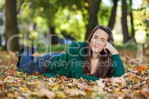 Woman lying in autumnal park