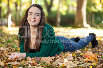 Woman lying in autumnal park