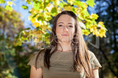 Young woman with long hair in autumn park