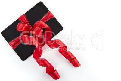 Tablet pc with christmas decorations on white