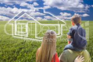 Young Family in Grass Field with Ghosted House in Front