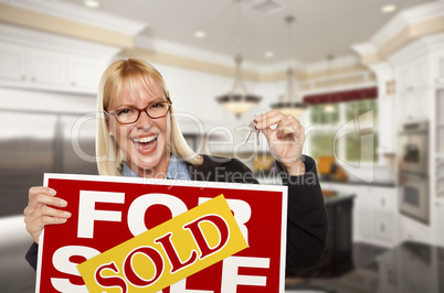 Young Woman Holding Sold Sign and Keys Inside New Kitchen