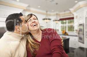 Mixed Race Couple Kissing Inside Beautiful Custom Kitchen